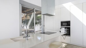 A modern kitchen with a large window, a built-in microwave, and a sleek countertop.