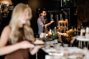 A bar setting with a bartender serving a drink.