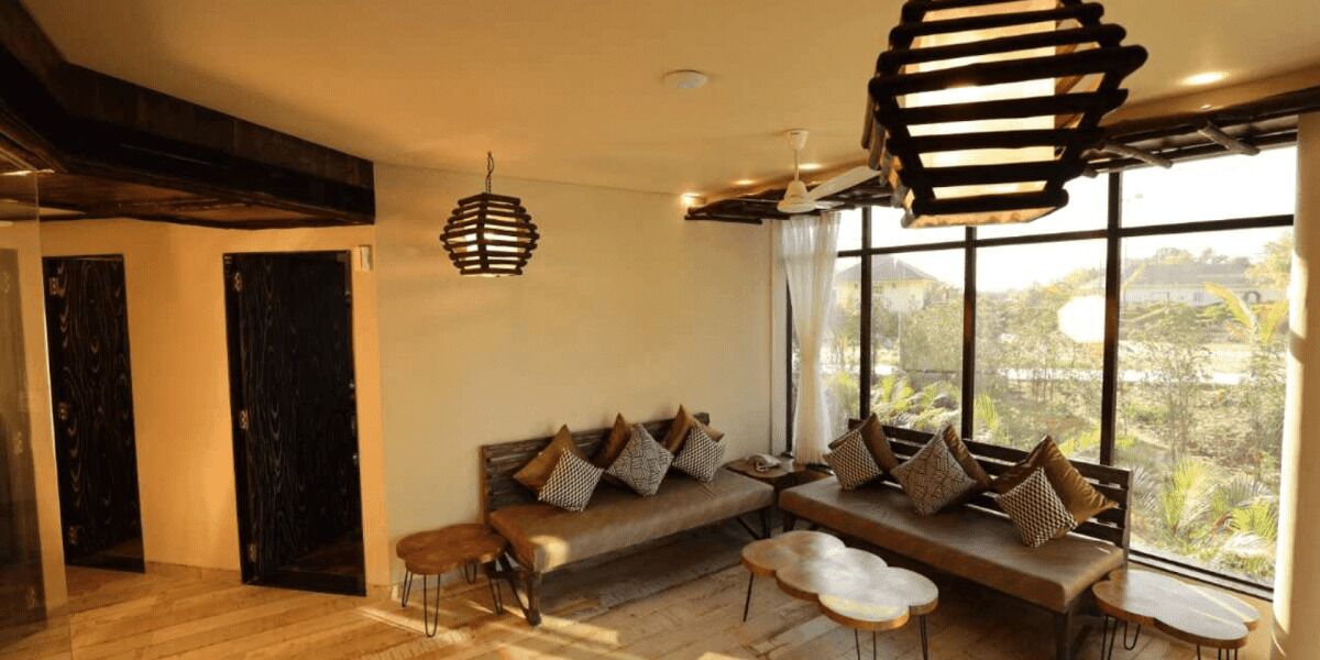 A modern living room with a sofa, coffee table, and pendant lights.