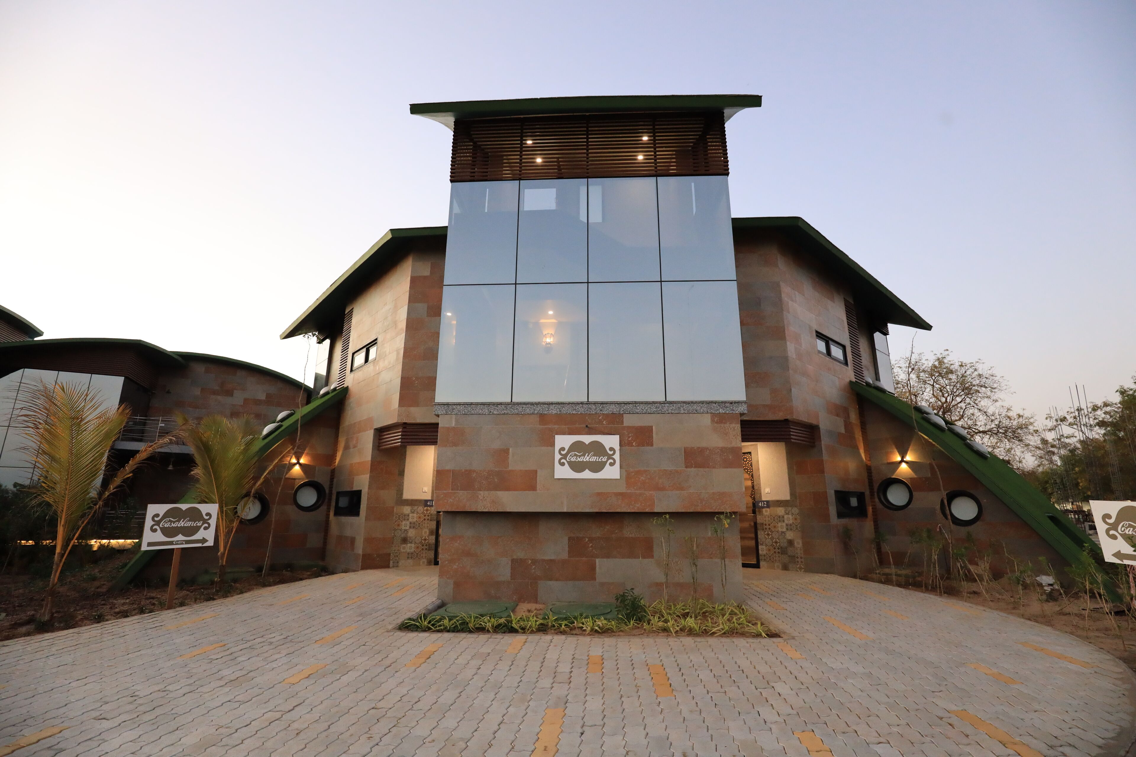 A modern building with a brick facade and a large glass window.