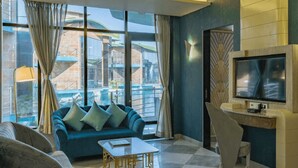 Una sala de estar moderna con un sofá azul, una mesa de centro y un televisor.