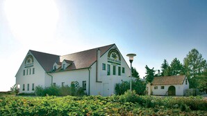 A large, white building with green trim and a sign that reads "Heurigen Pension." - Hanfthal-Hof (Laa an der Thaya)