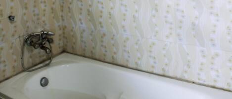 A bathroom with a bathtub, a shower, and a toilet.