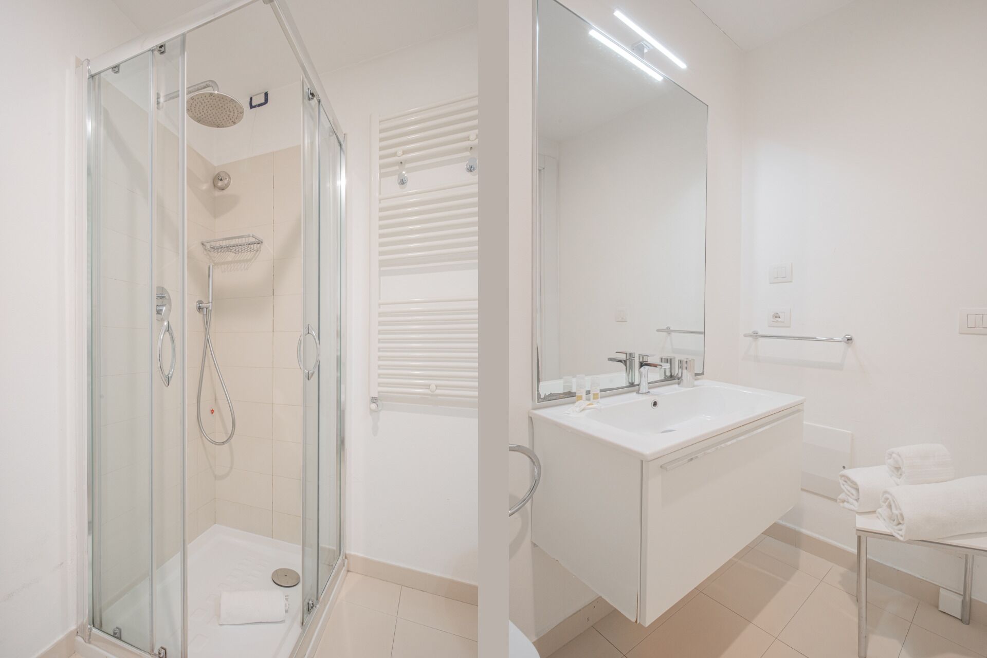 A modern bathroom with a glass-enclosed shower, a large mirror, and a white sink.