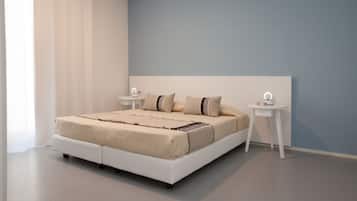 A modern bedroom with a large bed, two bedside tables, and a nightstand.