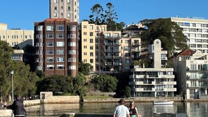 A riverside walkway with modern buildings, a bridge, and a park area. - BAYSIDE BLISS - PRIVATE & TRANQUIL WITH VIEWS, AIR CONDITIONING AND LIFT (Rushcutters Bay)