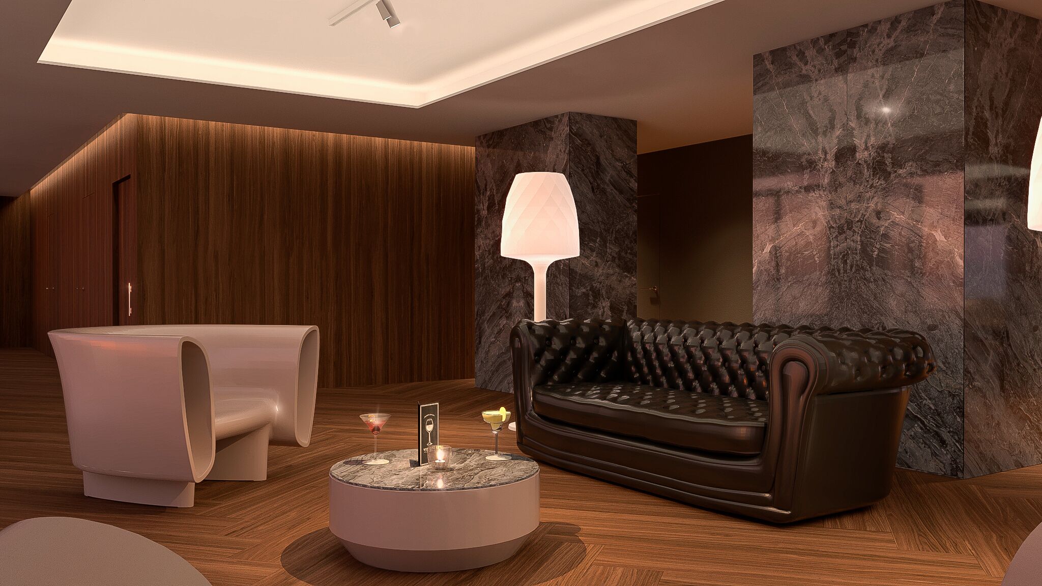 Un espace de détente moderne avec un canapé en cuir, un fauteuil blanc et une table basse en marbre surmontée d’une lampe.