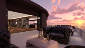 A modern outdoor seating area with a view of the sunset over the ocean. - Senator Gandia Hotel (Gandia)