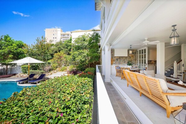 A modern outdoor living area with a pool, lounge chairs, and a wooden bench. - ★Burleigh Hamptons★ Surf views, Heated pool 200m to beach (Burleigh Heads)