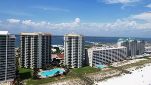 A high-rise hotel with multiple balconies, a pool, and a view of the ocean. - Your PooleParadise (Navarre Beach)