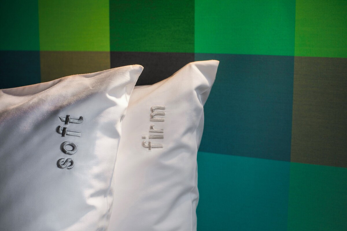 A pillow with the word 'soft' on it.