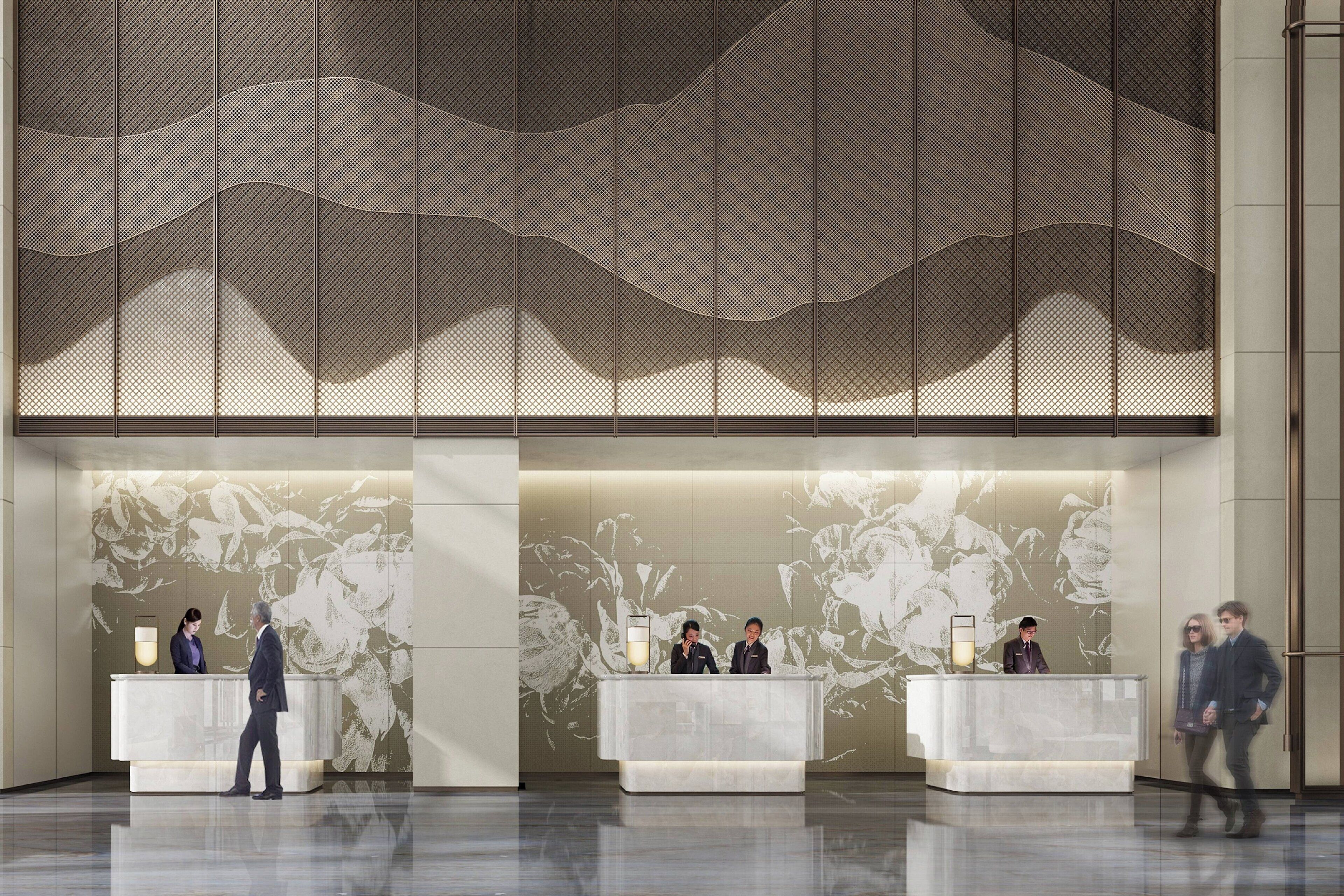 A reception area with three counters, a large abstract mural on the wall, and a polished floor.