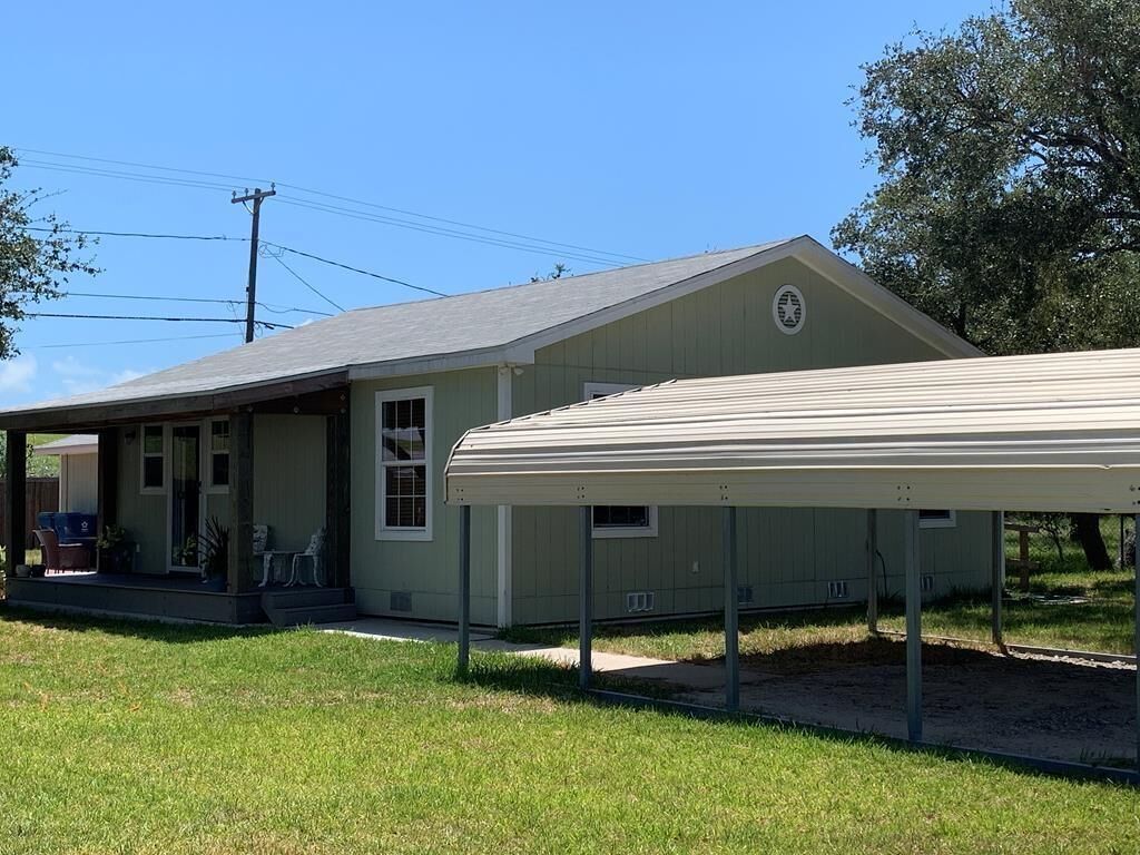 A single-story house with a covered porch and a garage.