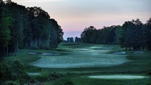 A golf course with sand bunkers, trees, and a clear sky. - Hampton Inn Verona at Turning Stone (Verona)