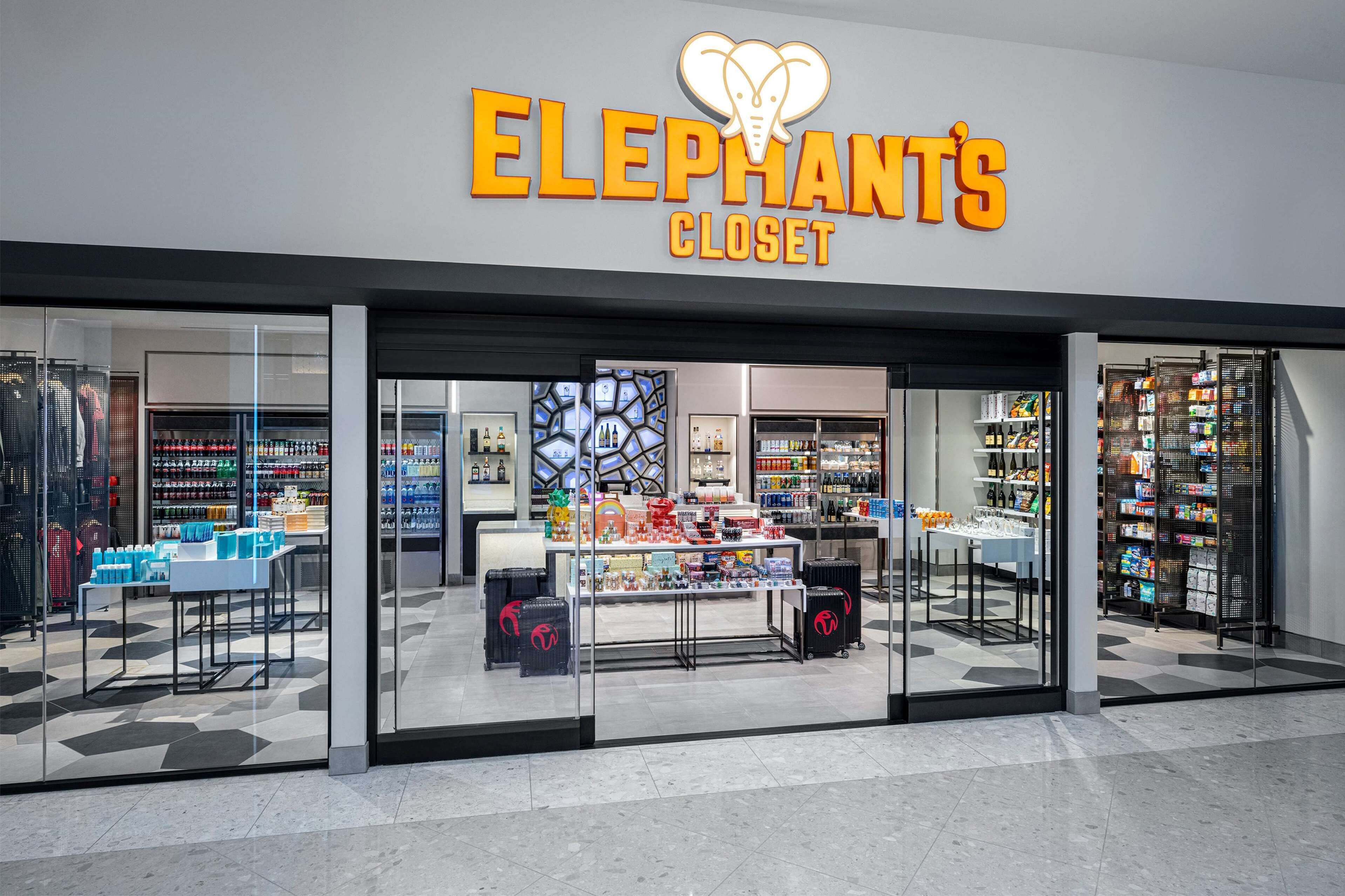 A storefront with a sign reading "ELEPHANTS CLOSET" and glass display windows showcasing various products.