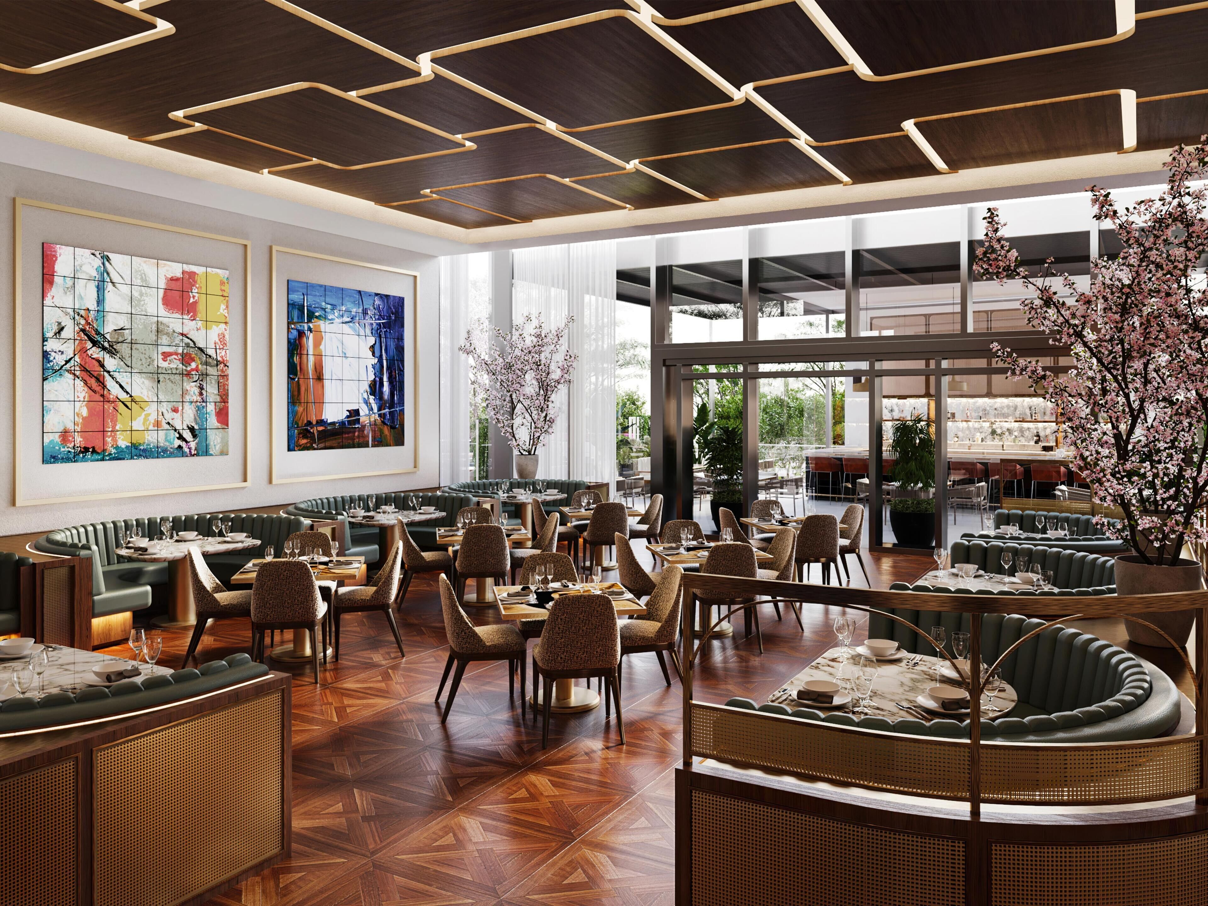 A spacious restaurant with high ceilings, modern lighting, and large windows.