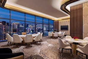 A modern conference room with a panoramic city view, large windows, and a stylish carpet design.