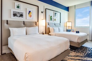 A hotel room with two beds, a large window, and artwork on the walls. - SERENA Hotel Aventura Miami, Tapestry Collection by Hilton (Aventura)