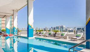 A rooftop pool with lounge chairs and a view of the city skyline. - SERENA Hotel Aventura Miami, Tapestry Collection by Hilton (Aventura)