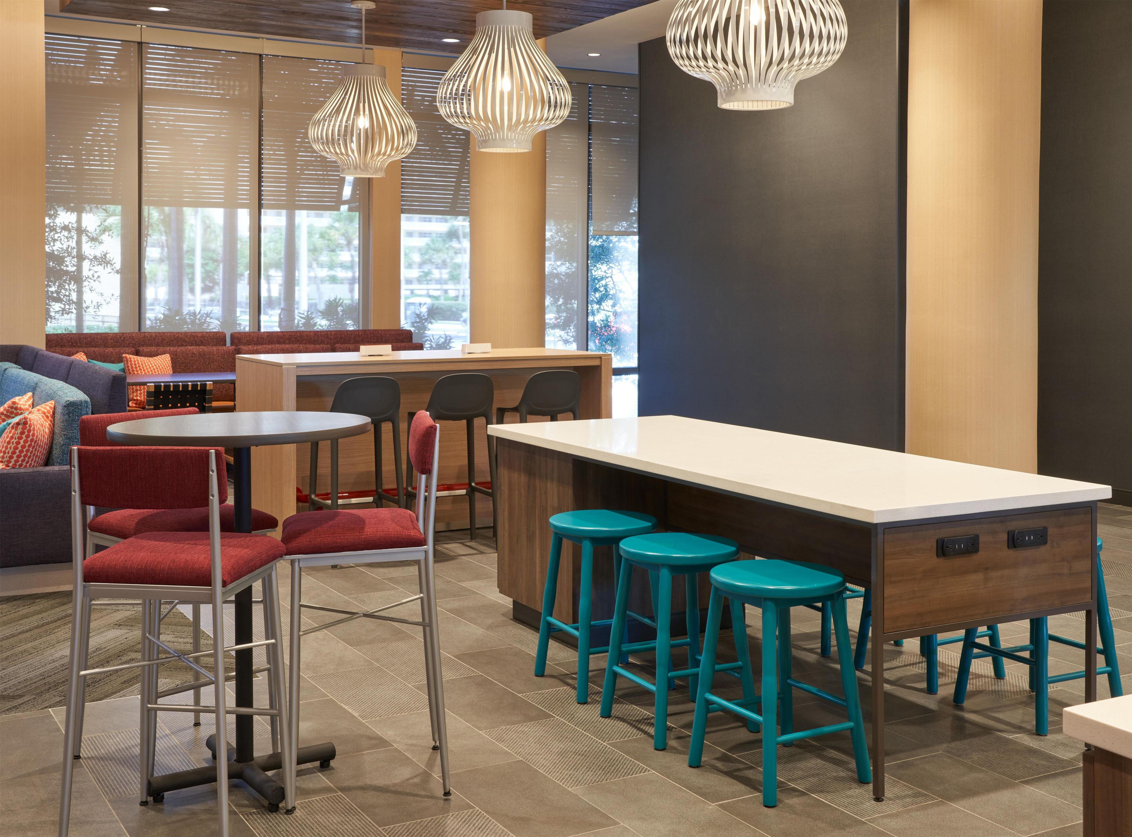 A modern interior with seating, a bar area, and pendant lighting.