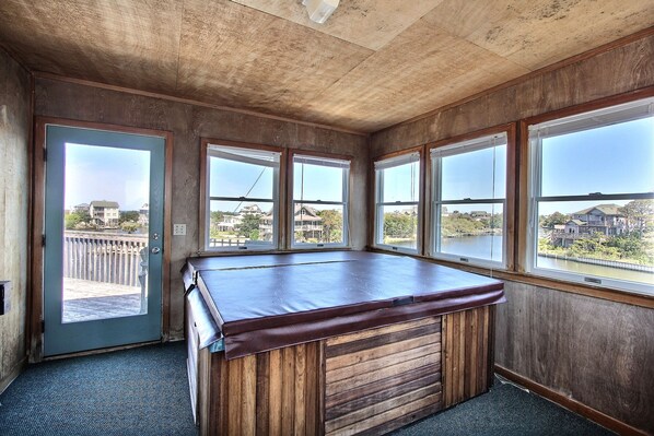 Enjoy a game of pool with a view of the surrounding residential area and a glimpse of the water.