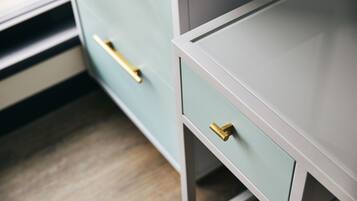 A close-up of a modern kitchen with light blue cabinetry and gold handles.