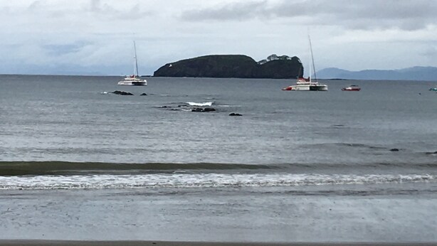 A beach with boats and a distant island. - Weekly Rental Beach Sunny , Party Town Costa Rica (Coco Beach)