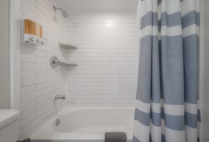 Bathtub, hair dryer, towels, soap