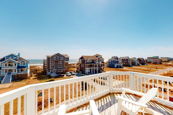 Stunning ocean views from a balcony overlooking a sandy beach.