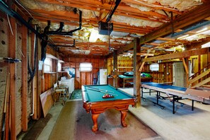 Recreational space with a pool table, billiards cue rack, and ping pong table.