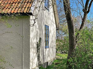A white building with a tiled roof and a window. - 6 Person Holiday Home in Lottorp (Löttorp)