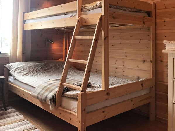 A bunk bed with a ladder, wooden walls, and a window. - 15 Person Holiday Home in Treungen (Nissedal)