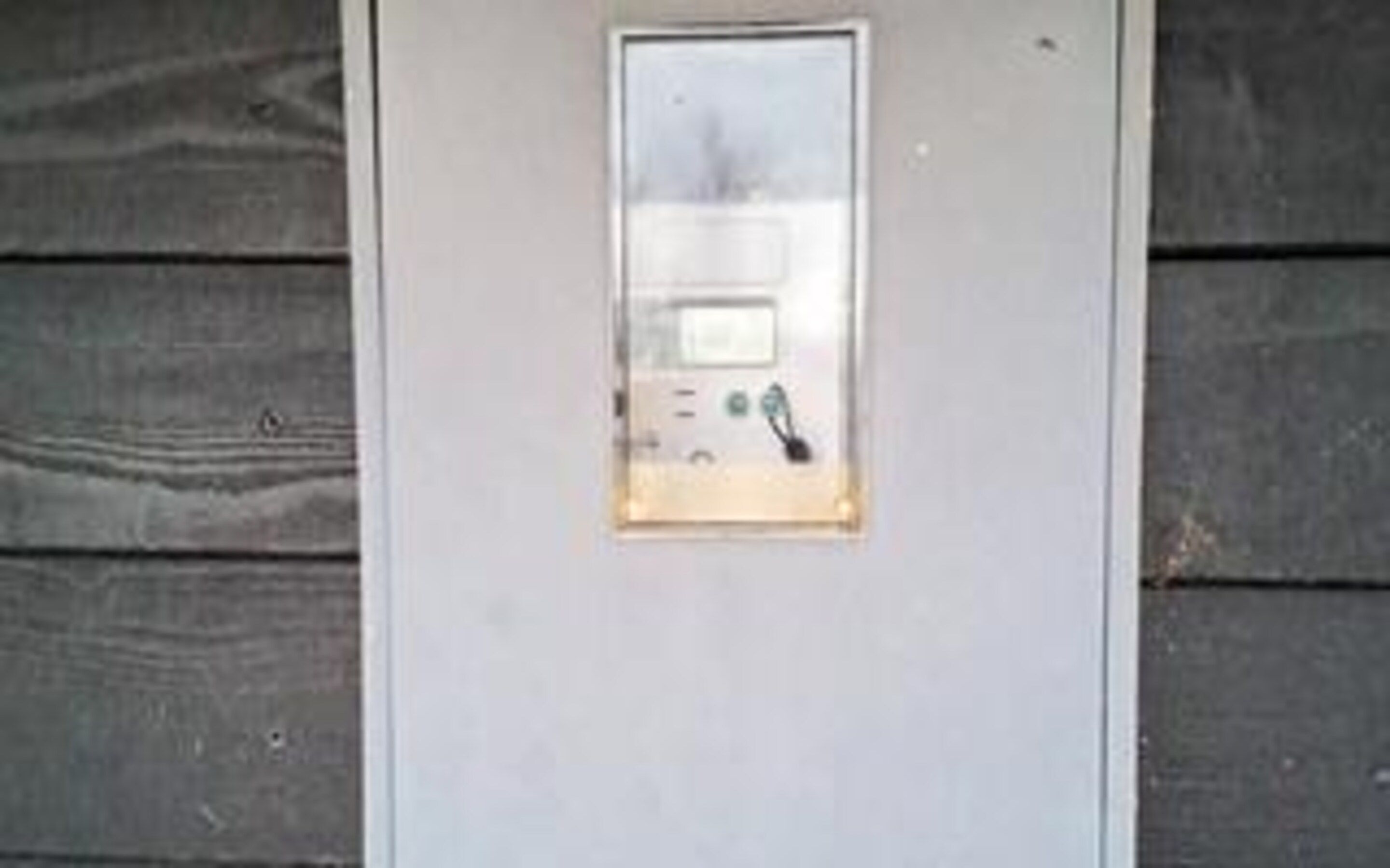 A metallic door with a keypad lock, a small display, and a keyhole.