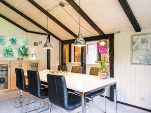 Enjoy meals in this stylish dining area with a long table and comfortable seating for four.