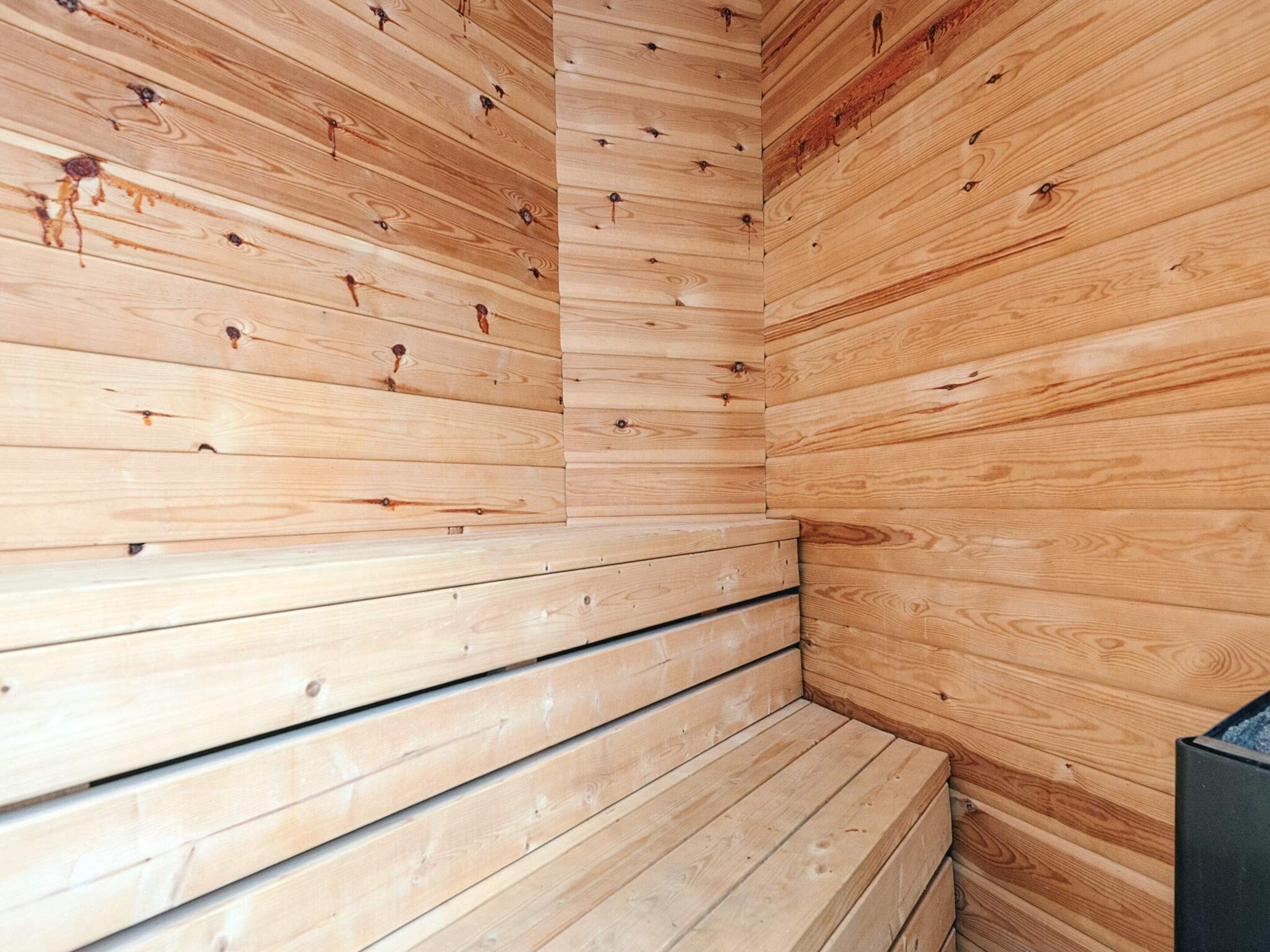 A sauna with wooden walls and benches.