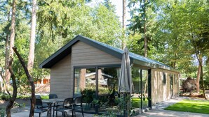 A modern house with a patio, outdoor seating, and a covered area. - Modern Chalet With Dishwasher, Near Utrecht (Maarn)