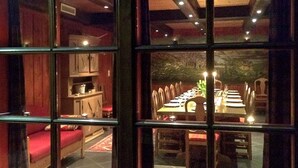 A dining area with a long table set for multiple people, surrounded by chairs. - 3 Person Holiday Home in BOE Telemark (Midt-Telemark)