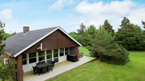 A house with a large deck, a chimney, and a satellite dish. - Holiday Home in BlÃ¥vand (Blavand)