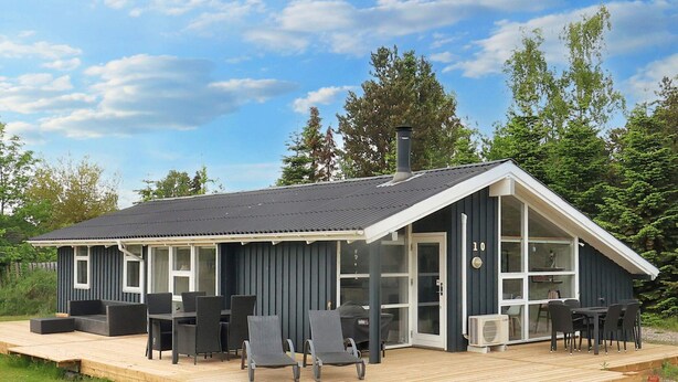 A modern house with a deck, large windows, and outdoor furniture. - Holiday Home in VÃ¦ggerlÃ¸se (Vaeggerlose)