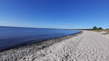 A sandy beach with a clear blue sky.