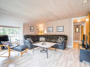 A modern living room with a sectional sofa, a coffee table, and a chaise lounge. - 4 Star Holiday Home in Norre Nebel (Norre Nebel)