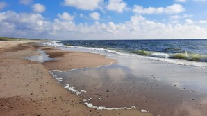 A beach with wet sand, waves, and a clear sky. - 4 Star Holiday Home in Henne (Henne)
