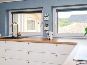 A kitchen with a window, a sink, and a countertop. - 4 Star Holiday Home in Hvide Sande (Hvide Sande)
