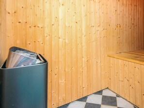 A corner of a room with wooden paneling, a trash bin, and a checkered floor tile. - 4 Star Holiday Home in Oksbol (Oksbol)