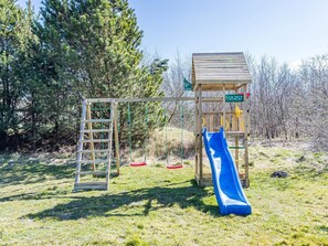 A playground with a wooden slide and a ladder. - 5 Star Holiday Home in Norre Nebel (Norre Nebel)