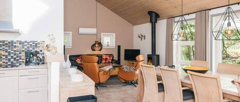 A modern interior with a kitchen, dining area, and living space.