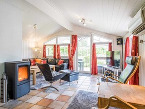 A cozy room with a fireplace, seating, and a TV.