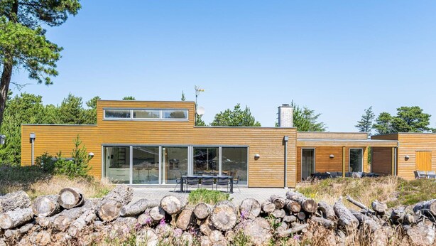 A modern two-story house with large glass windows and a wooden exterior. - 6 Person Holiday Home in Henne (Henne)