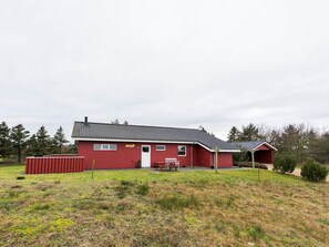 A red building with a tiled roof, a covered porch, and a small attached structure. - 4 Star Holiday Home in Tarm (Tarm)