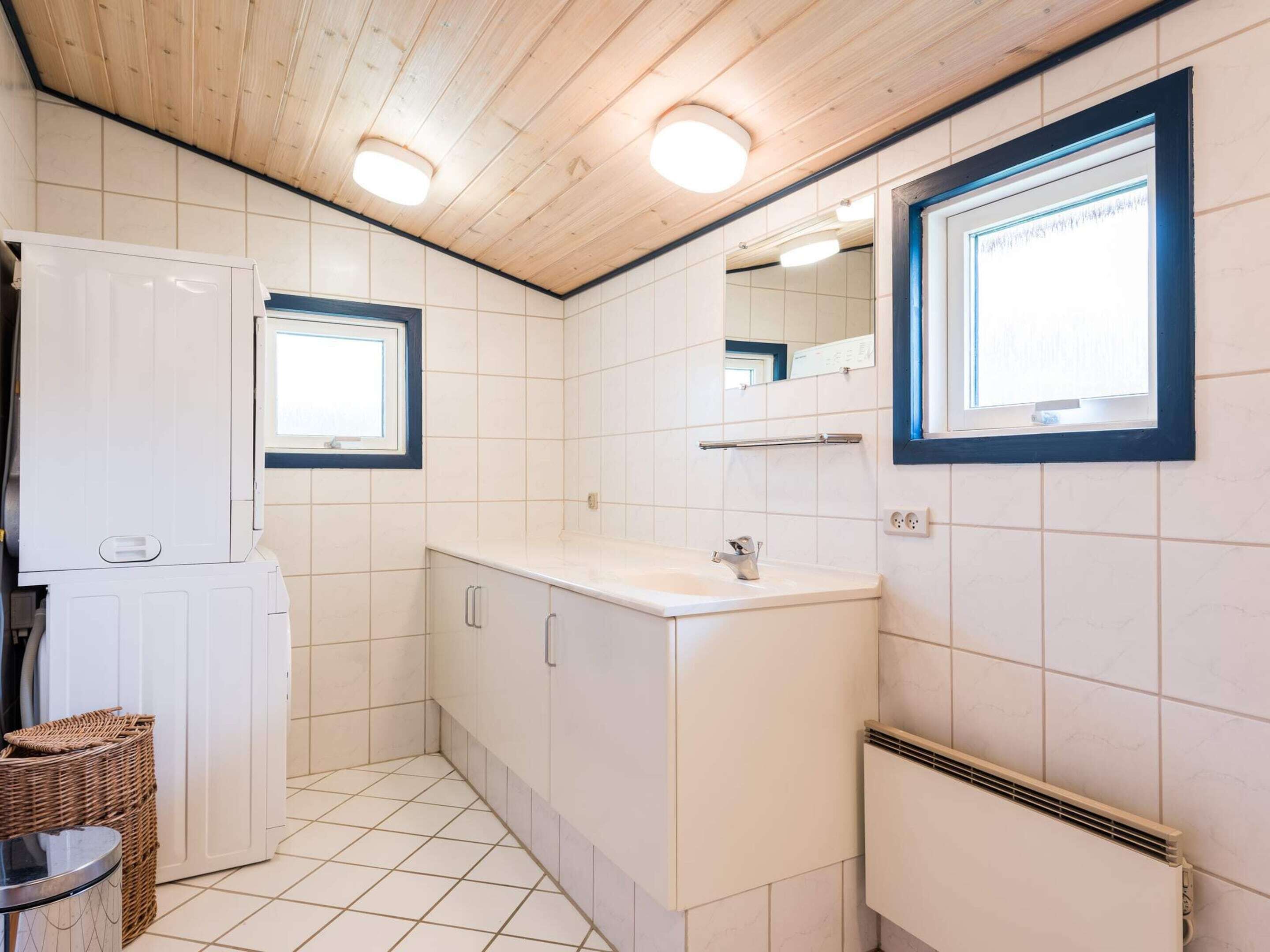 A compact kitchen with a built-in stove, a sink, and a window.